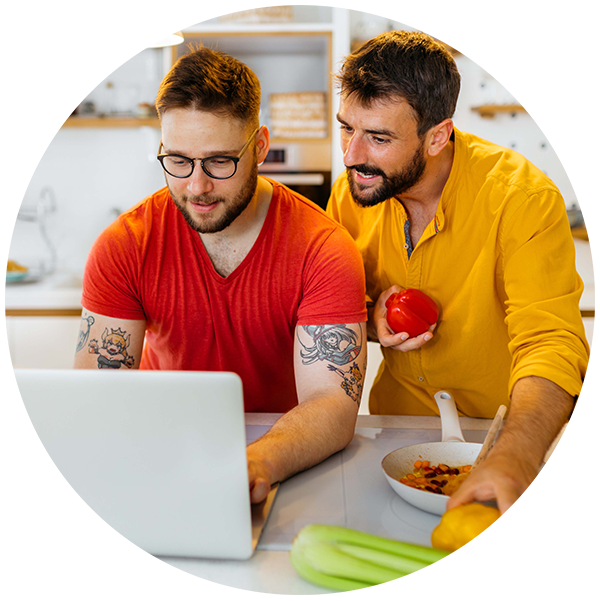 Happy couple looking at laptop